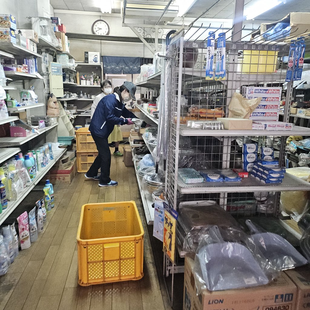 店内の棚を回りながら買取商品を仕分けしている様子